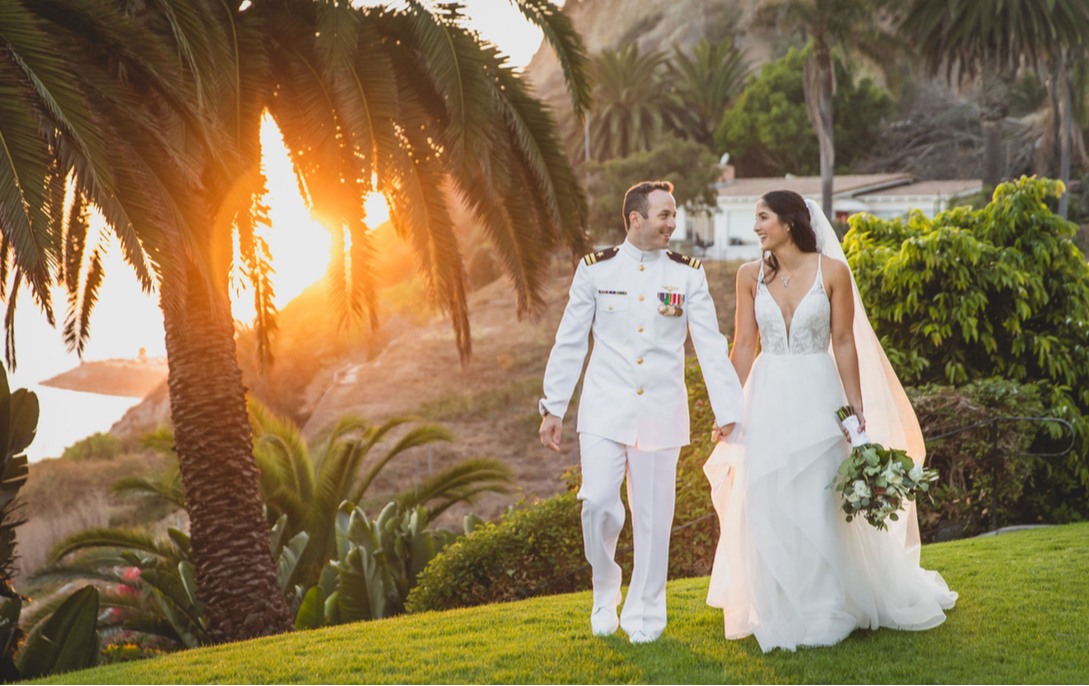 Bride and Groom walking in Bel-Air at the middle of a sunset taken by Los Angeles Wedding Videographer One in a Million Films